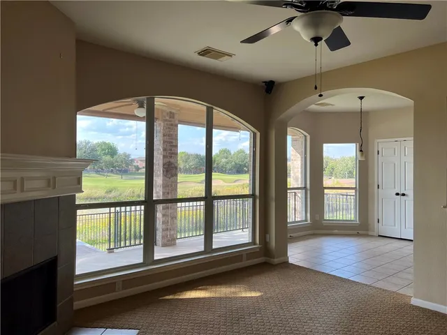 a view of an empty room with a window