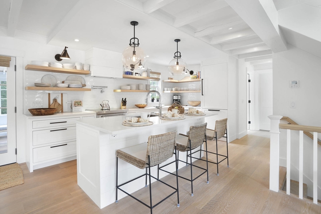 37 Rd To The Plaines Edgartown, MA 02539 - Photo 17 of 42 a kitchen with white cabinets and chairs