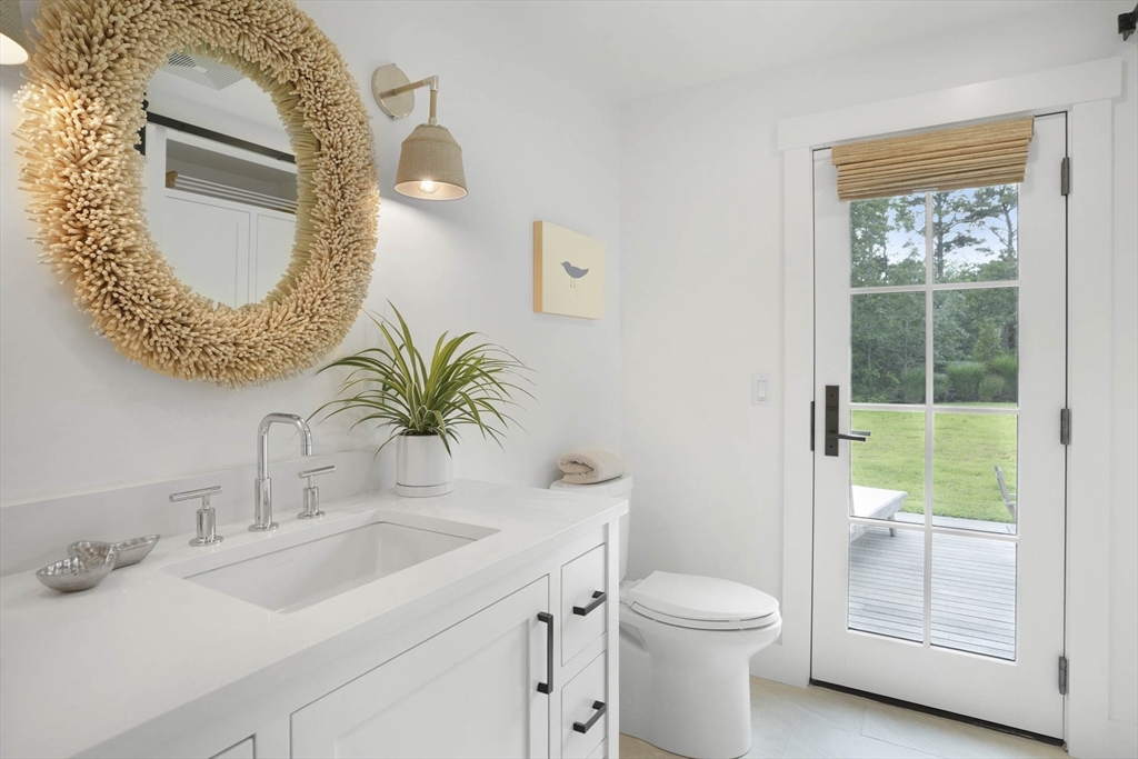 37 Rd To The Plaines Edgartown, MA 02539 - Photo 19 of 42 a bathroom with a toilet sink vanity and mirror