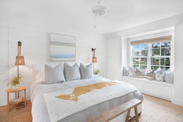 a bedroom with a large bed and a large window