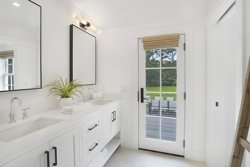 37 Rd To The Plaines Edgartown, MA 02539 - Photo 26 of 42 a bathroom with a double vanity sink and a window