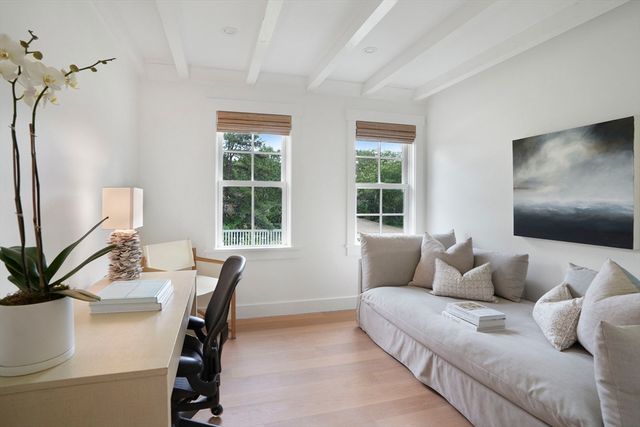 a living room with furniture and floor to ceiling window