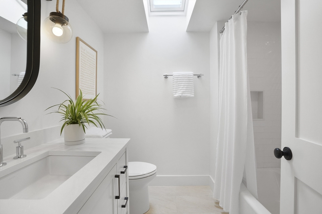 37 Rd To The Plaines Edgartown, MA 02539 - Photo 33 of 42 a bathroom with a granite countertop sink a toilet a mirror and shower