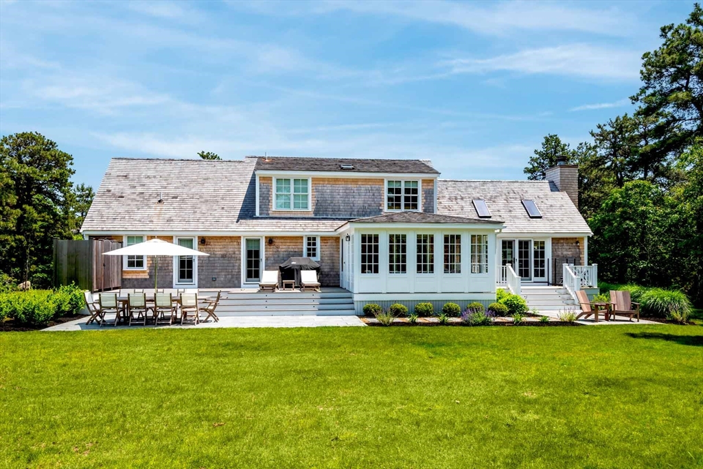 37 Rd To The Plaines Edgartown, MA 02539 - Photo 40 of 42 a front view of a house with a garden and swimming pool