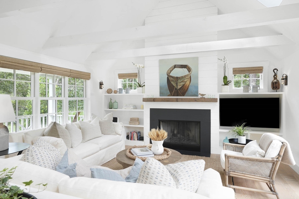 37 Rd To The Plaines Edgartown, MA 02539 - Photo 7 of 42 a living room with furniture a fireplace and a flat screen tv