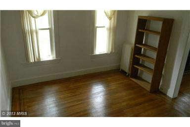 227 Mallow Hill Road Baltimore, MD 21229 - Photo 5 of 11 a view of empty room with wooden floor and fan