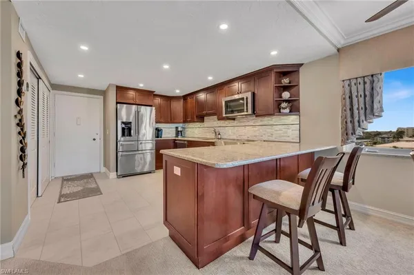 a kitchen with cabinets a sink and appliances