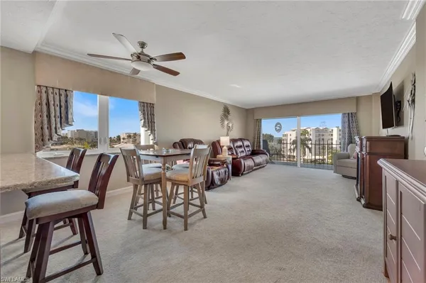 a kitchen with stainless steel appliances kitchen island granite countertop a refrigerator and a stove top oven