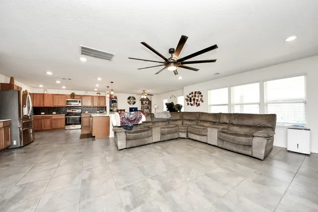a living room with furniture and kitchen view