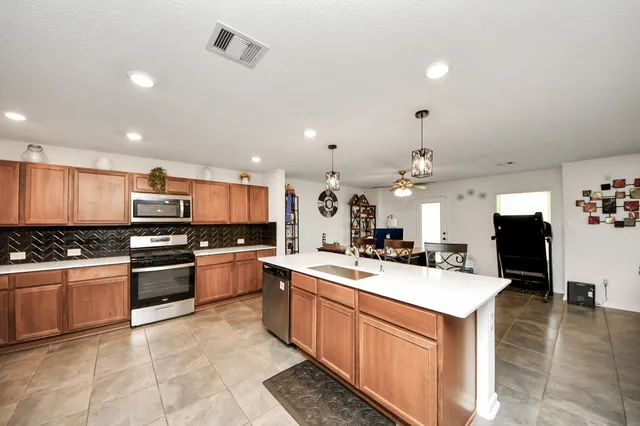 a kitchen with a sink stove and oven