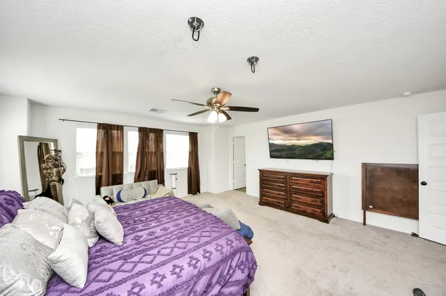 a bedroom with a bed and a chandelier