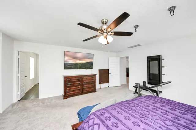 a spacious bedroom with a bed and window