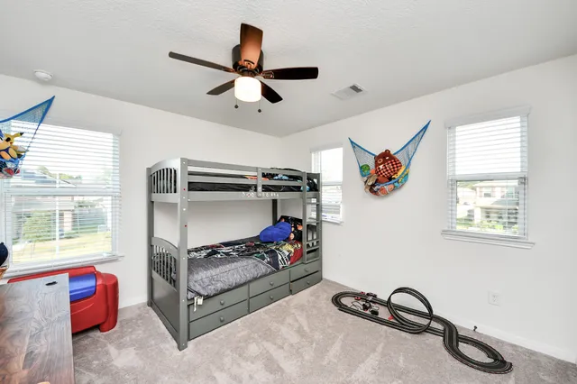 a bed room with furniture and windows