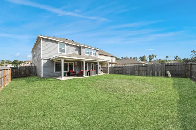 a view of a house with a yard and sitting area