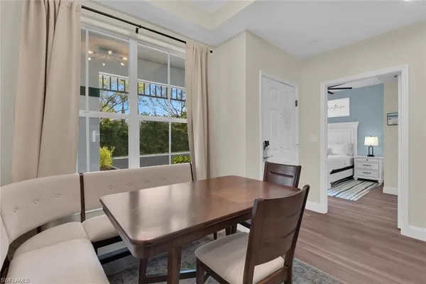 a view of a dining room with furniture and wooden floor