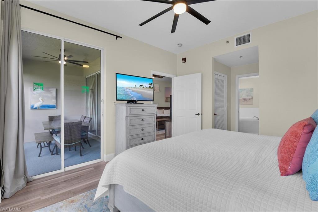 7880 Mahogany Run Lane, Unit 1614 Naples, FL 34113 - Photo 13 of 38 a bedroom with a bed and a flat screen tv