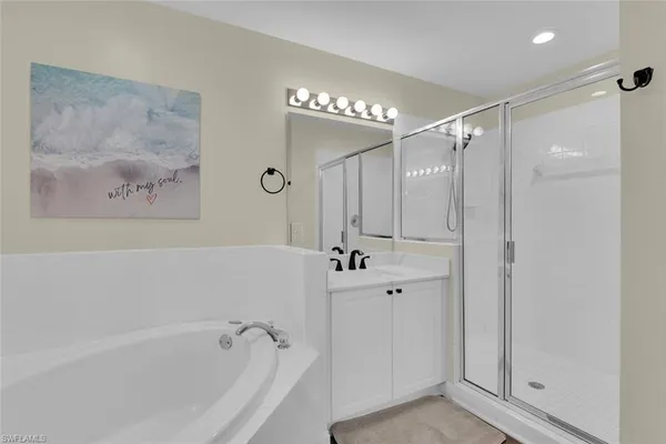 a bathroom with a bathtub a shower and a shower