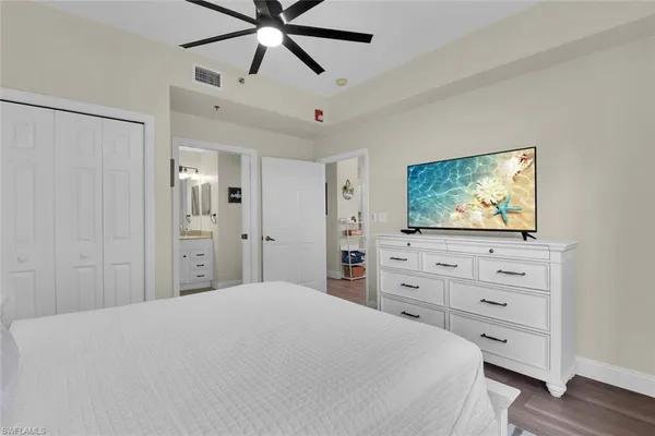 a bedroom with a bed and a flat screen tv