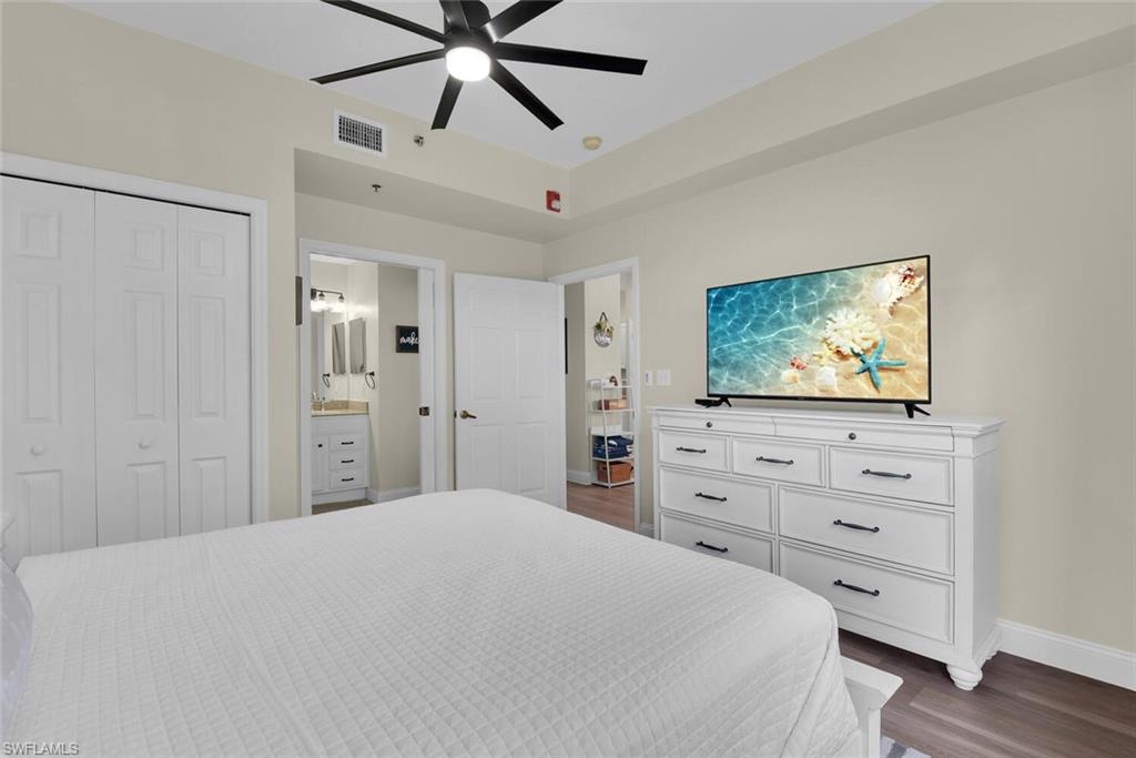 7880 Mahogany Run Lane, Unit 1614 Naples, FL 34113 - Photo 17 of 38 a bedroom with a bed and a flat screen tv