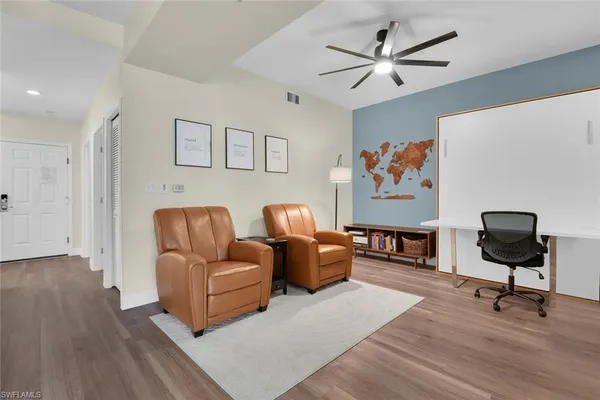 a living room with furniture ceiling fan and a rug