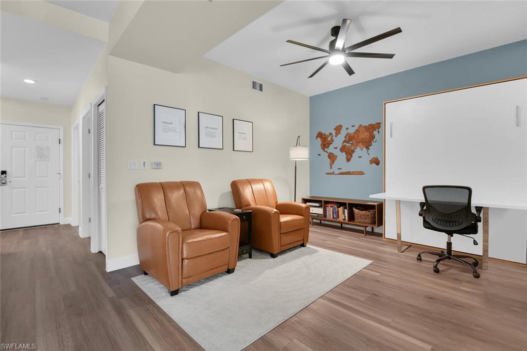 7880 Mahogany Run Lane, Unit 1614 Naples, FL 34113 - Photo 19 of 38 a living room with furniture ceiling fan and a rug