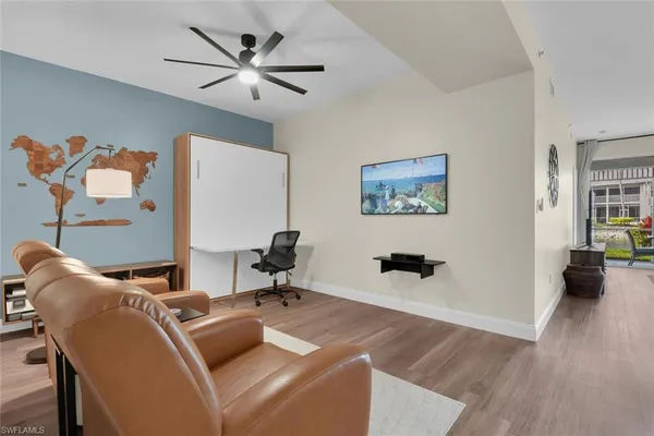 a work room with furniture and wooden floor