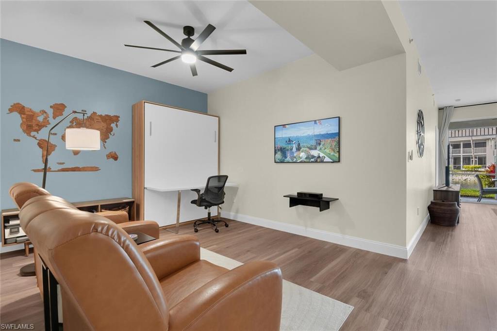 7880 Mahogany Run Lane, Unit 1614 Naples, FL 34113 - Photo 20 of 38 a work room with furniture and wooden floor