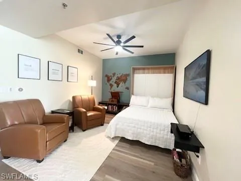 a bedroom with a bed couch and a window