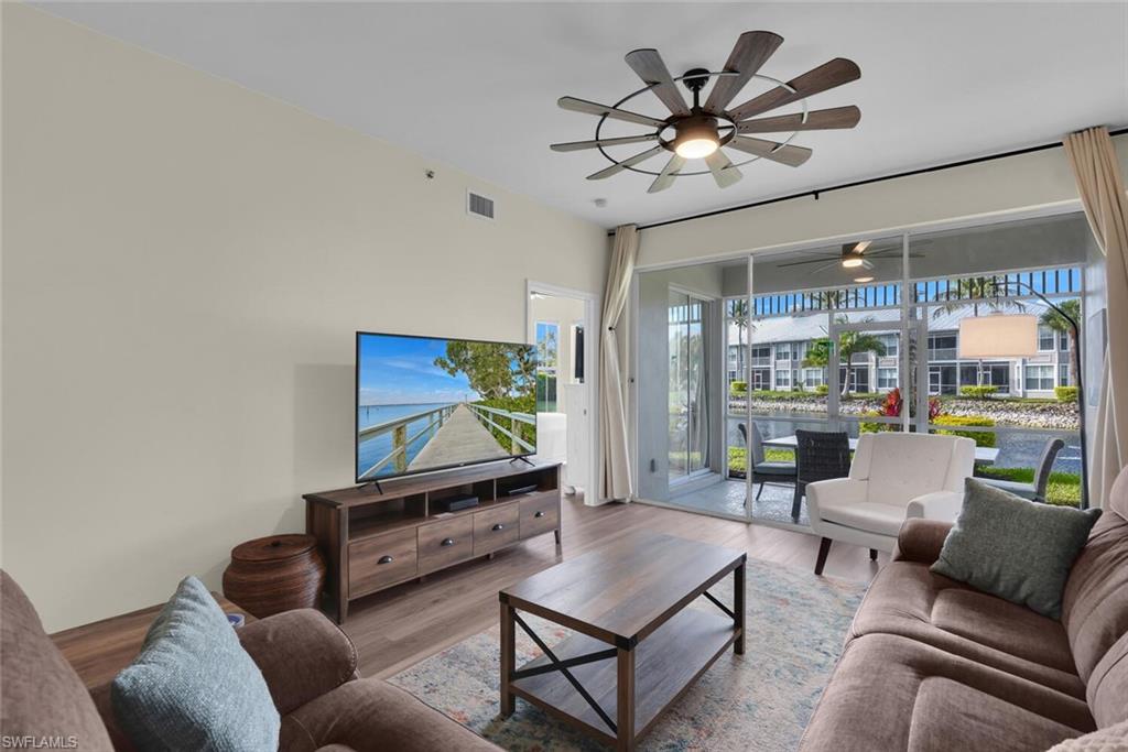 7880 Mahogany Run Lane, Unit 1614 Naples, FL 34113 - Photo 3 of 38 a living room with furniture and a flat screen tv