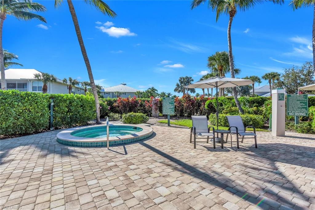 7880 Mahogany Run Lane, Unit 1614 Naples, FL 34113 - Photo 33 of 38 a view of a chairs and table in backyard