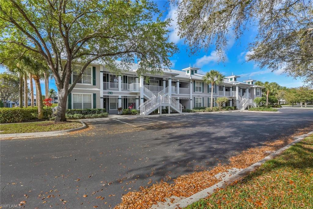 7880 Mahogany Run Lane, Unit 1614 Naples, FL 34113 - Photo 38 of 38 a front view of a house with a yard