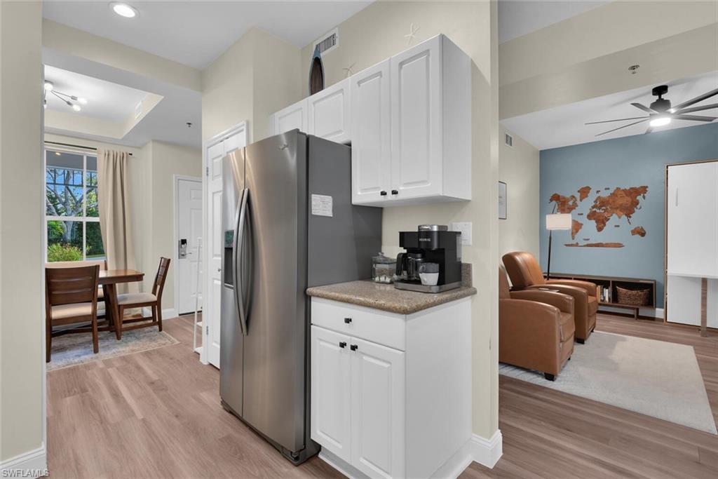 7880 Mahogany Run Lane, Unit 1614 Naples, FL 34113 - Photo 8 of 38 a kitchen with stainless steel appliances a stove a refrigerator and a refrigerator