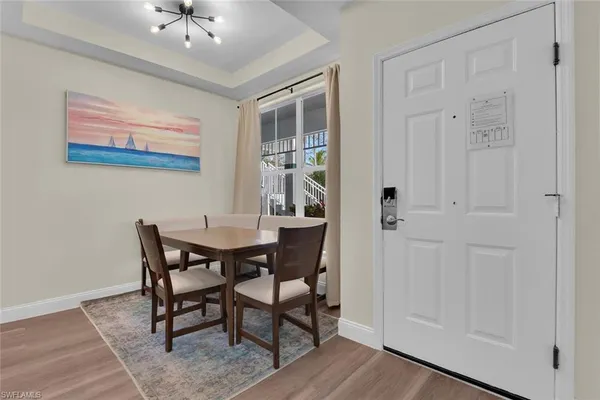 a view of a dining room with furniture and chandelier