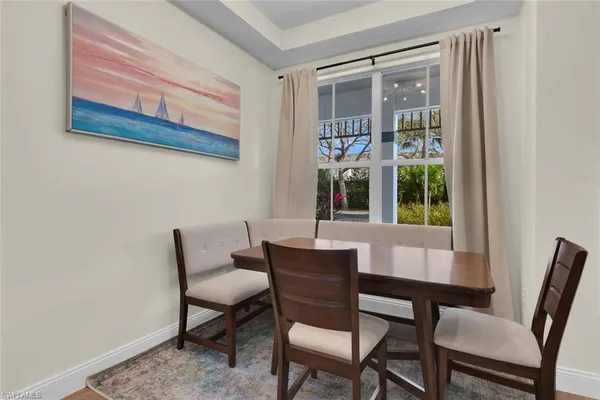 a view of a dining room with furniture and window