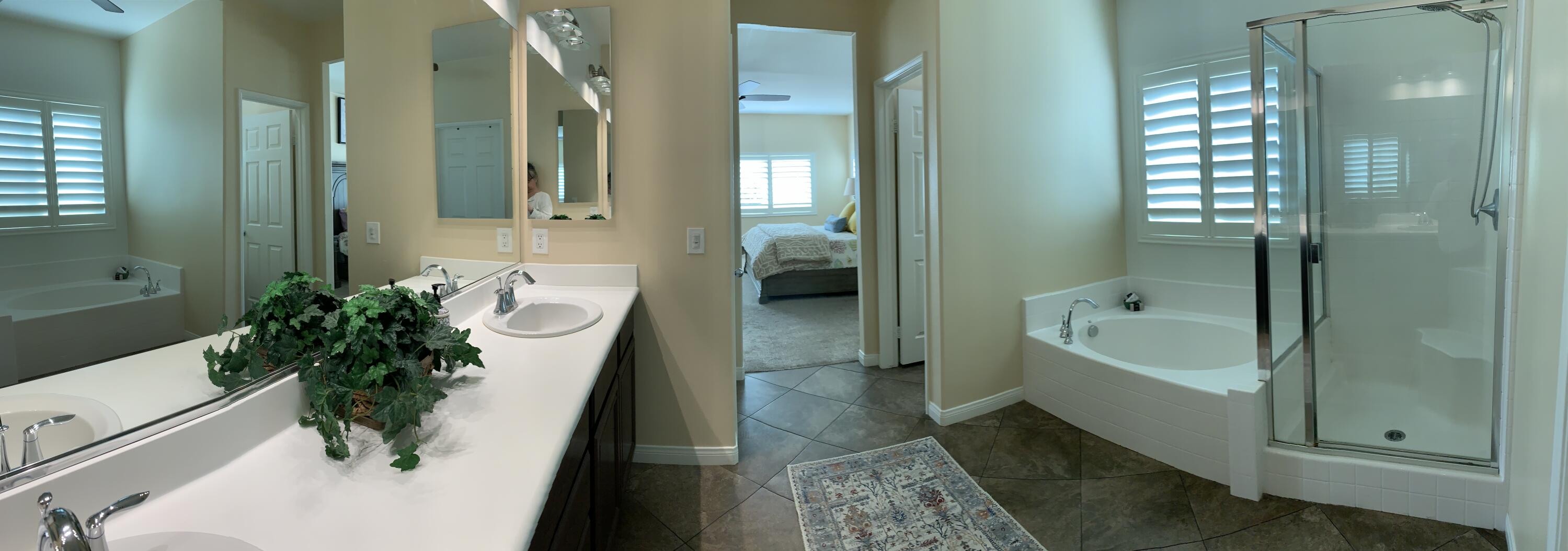 82515 Grass Flat Lane Indio, CA 92203 - Photo 14 of 44 a bathroom with a tub shower and a mirror