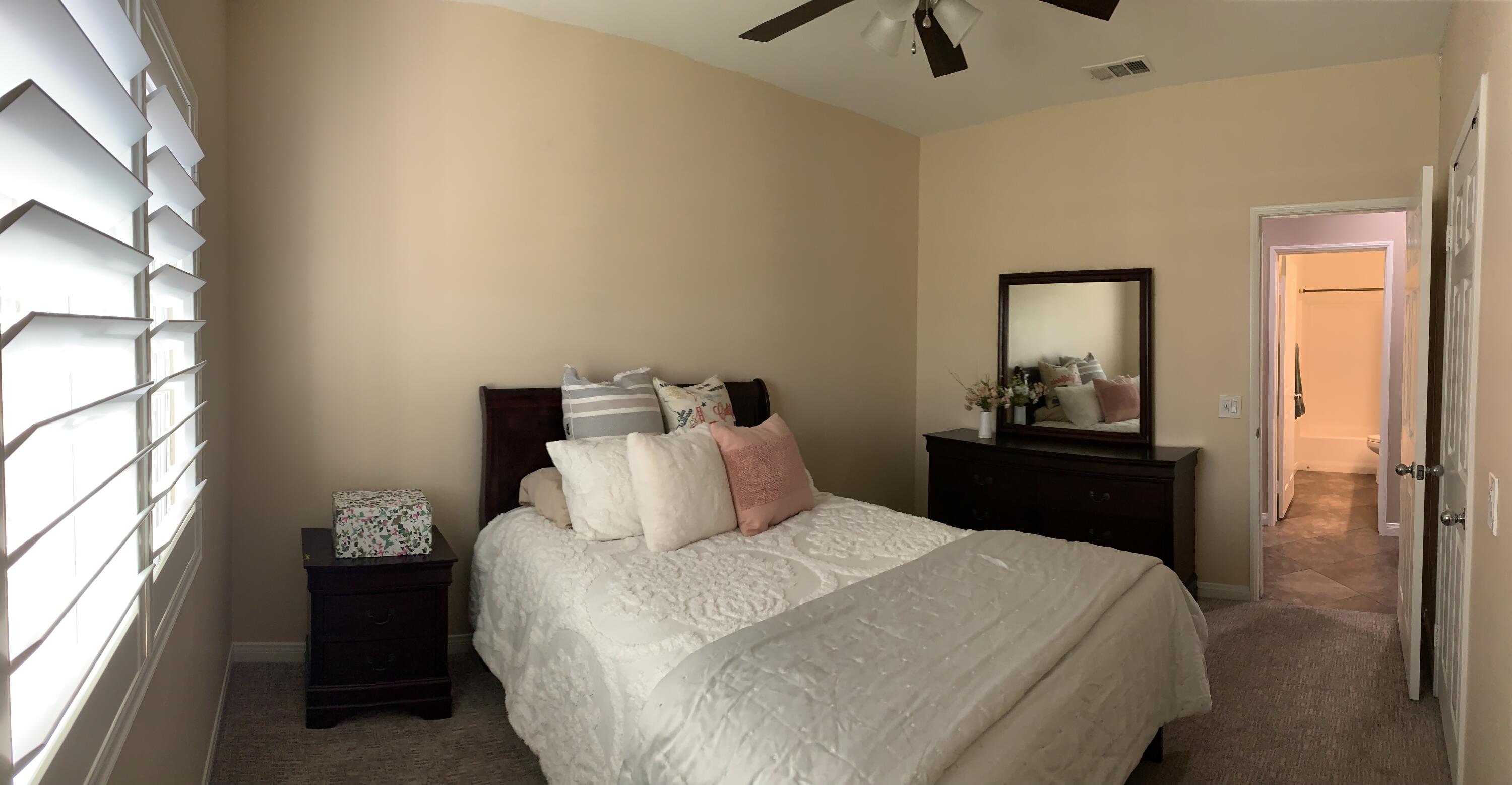 82515 Grass Flat Lane Indio, CA 92203 - Photo 21 of 44 a bedroom with a bed and a chandelier