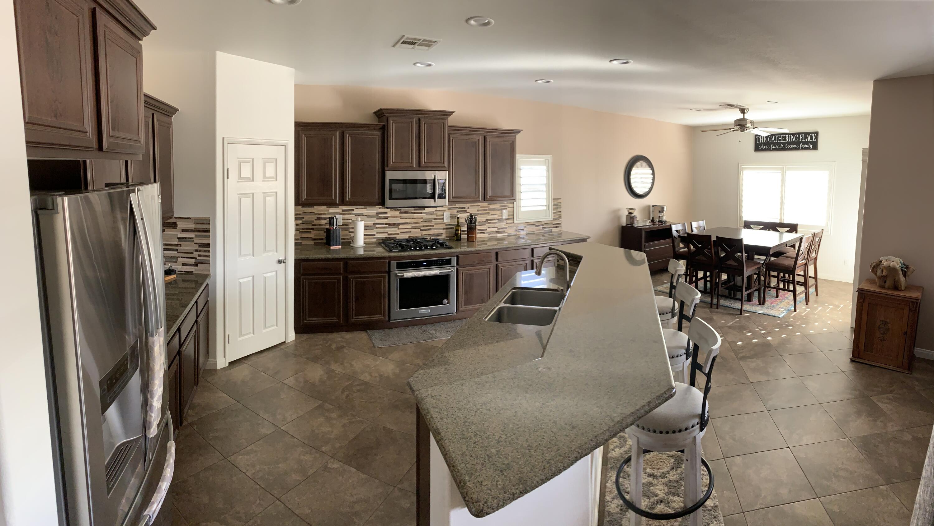 82515 Grass Flat Lane Indio, CA 92203 - Photo 4 of 44 a large kitchen with stainless steel appliances granite countertop a stove refrigerator and a sink