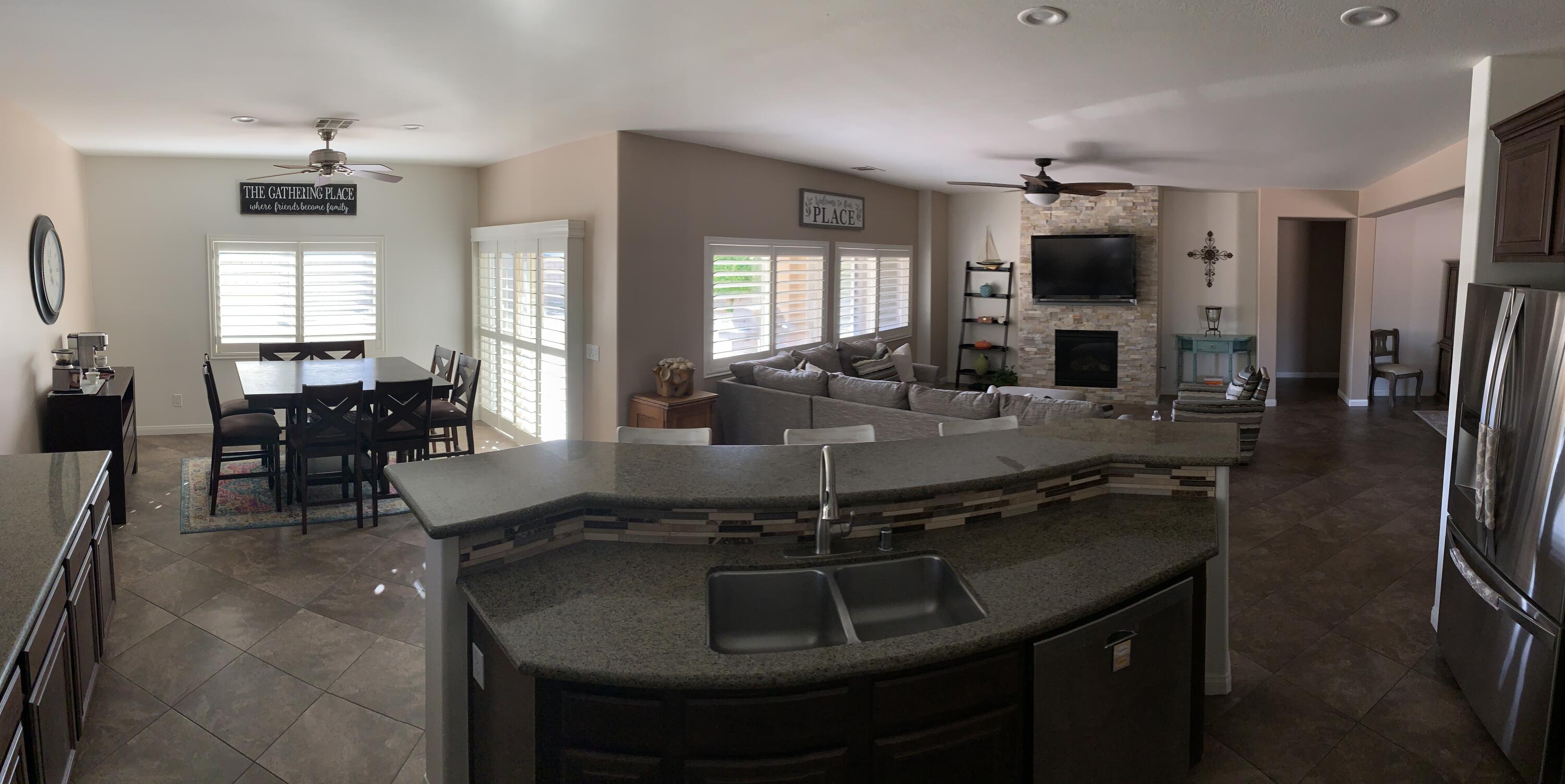 82515 Grass Flat Lane Indio, CA 92203 - Photo 6 of 44 a kitchen with counter space dining table and chairs
