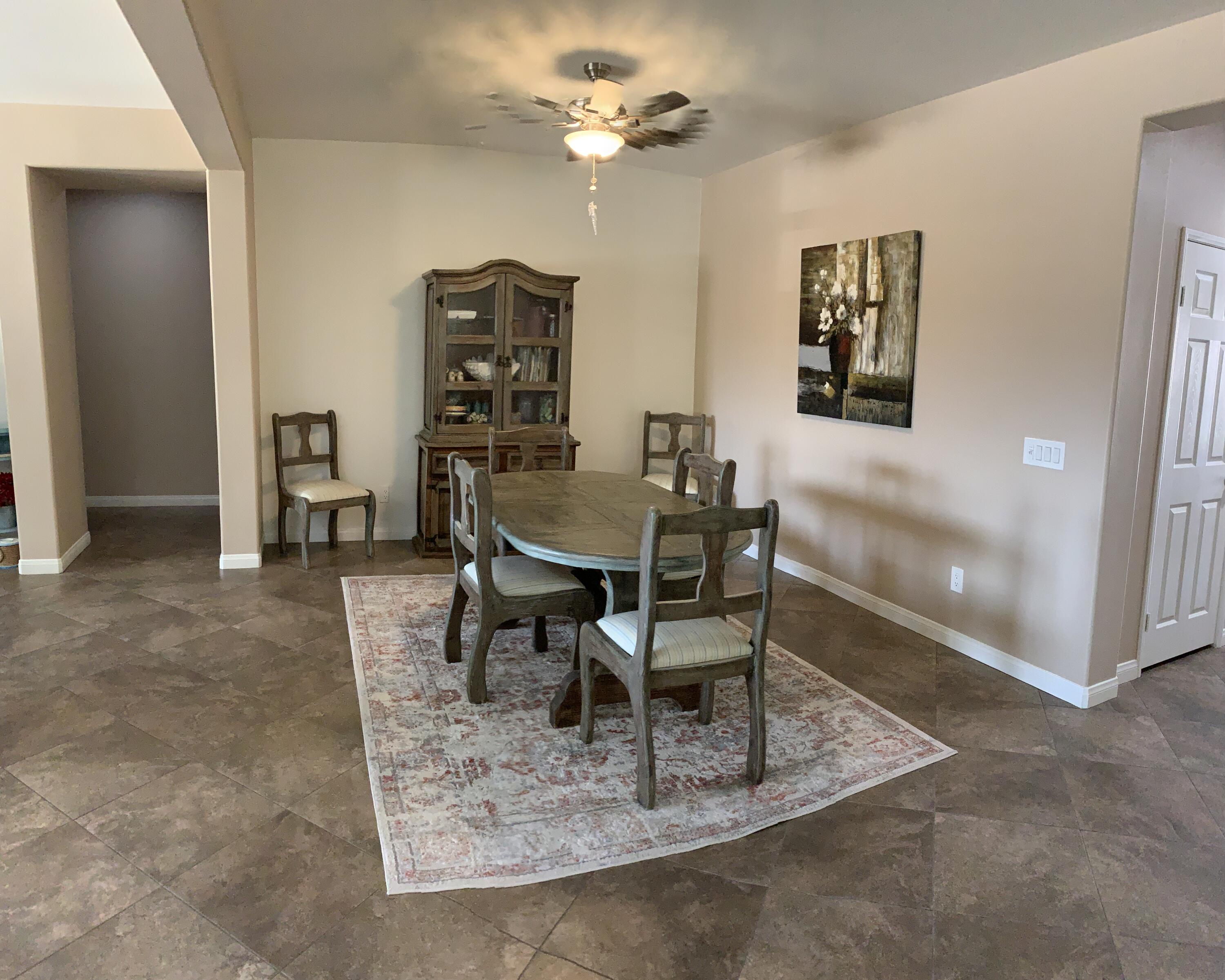 82515 Grass Flat Lane Indio, CA 92203 - Photo 9 of 44 a dining room with furniture and a chandelier