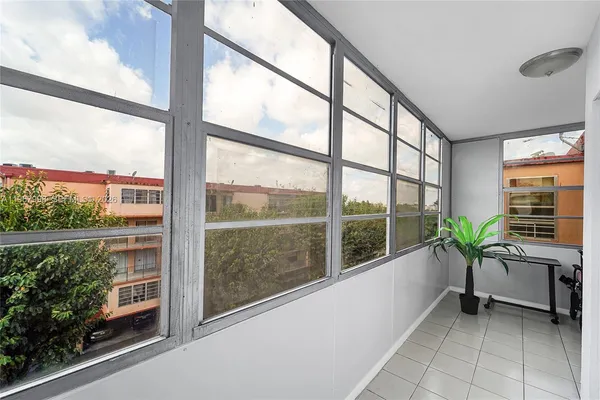 a room with window and pool table