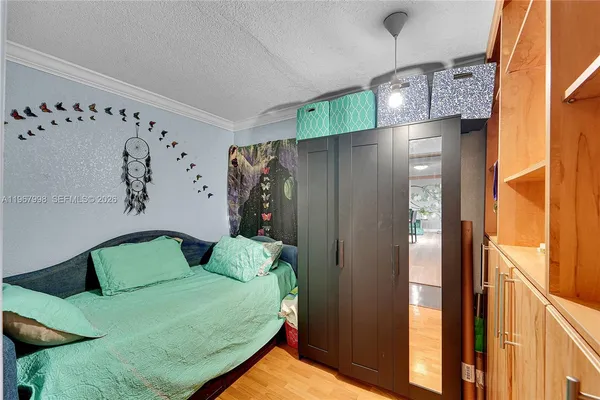 a bed room with a bed window and a table in it