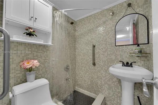 a bathroom with a sink toilet and shower