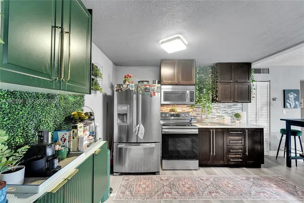 a kitchen with refrigerator and cabinets