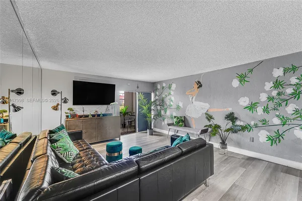 a living room with furniture and a flat screen tv