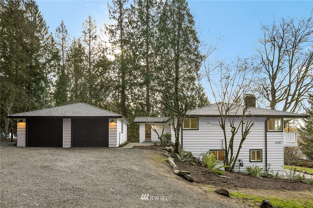 24207 39th Avenue Southeast Bothell, WA 98021 - Photo 2 of 39 a front view of a house with a yard and garage