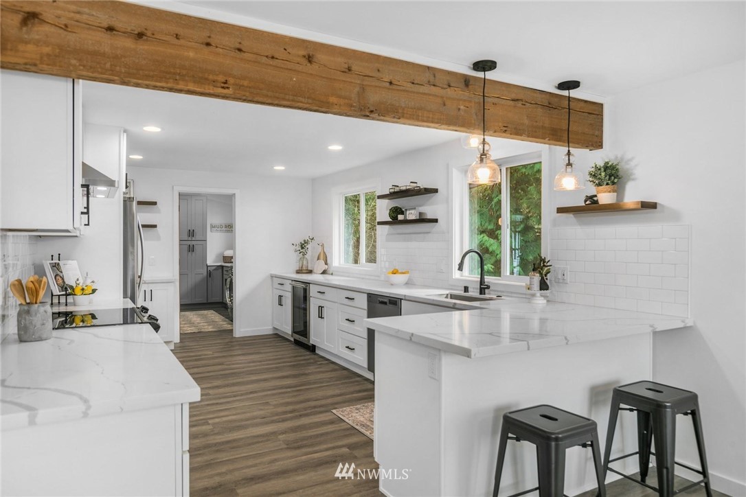 24207 39th Avenue Southeast Bothell, WA 98021 - Photo 11 of 39 a large white kitchen with a large window