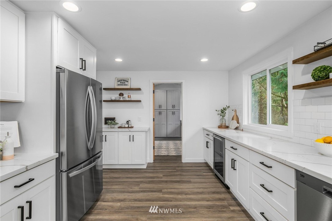 24207 39th Avenue Southeast Bothell, WA 98021 - Photo 12 of 39 a kitchen with stainless steel appliances a refrigerator sink and cabinets