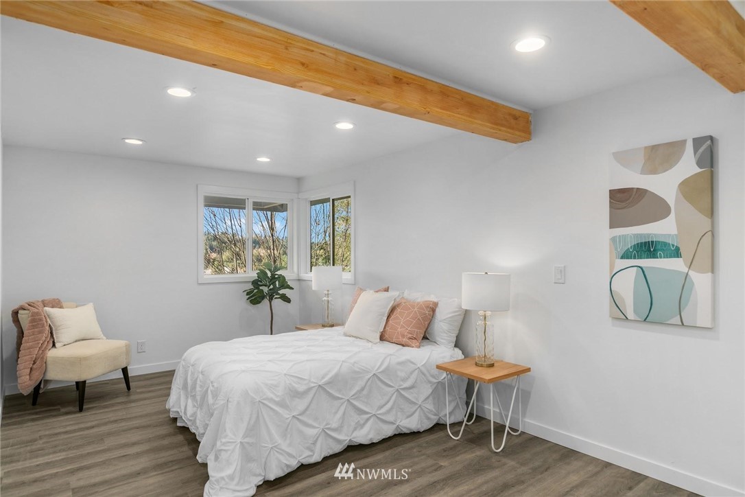 24207 39th Avenue Southeast Bothell, WA 98021 - Photo 18 of 39 a bedroom with a bed and wooden floor