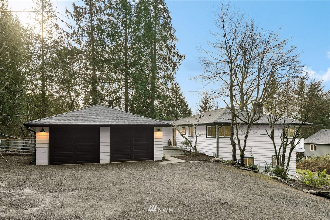 24207 39th Avenue Southeast Bothell, WA 98021 - Photo 3 of 39 a view of a house with large windows and a large tree