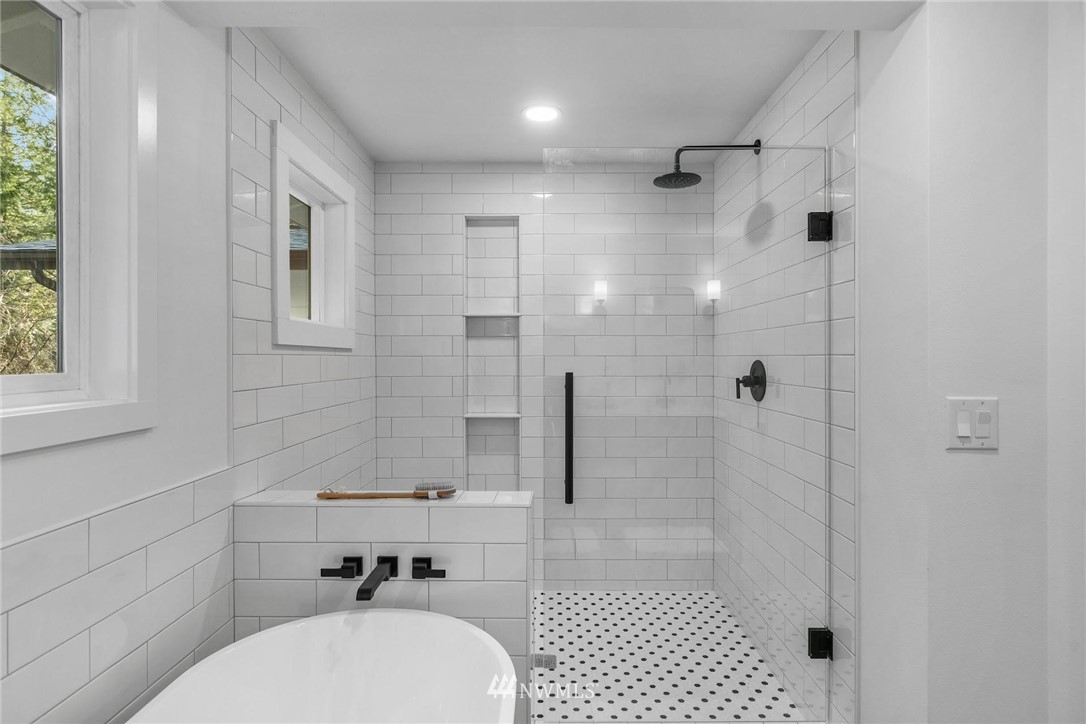 24207 39th Avenue Southeast Bothell, WA 98021 - Photo 21 of 39 a bathroom with a sink toilet and shower